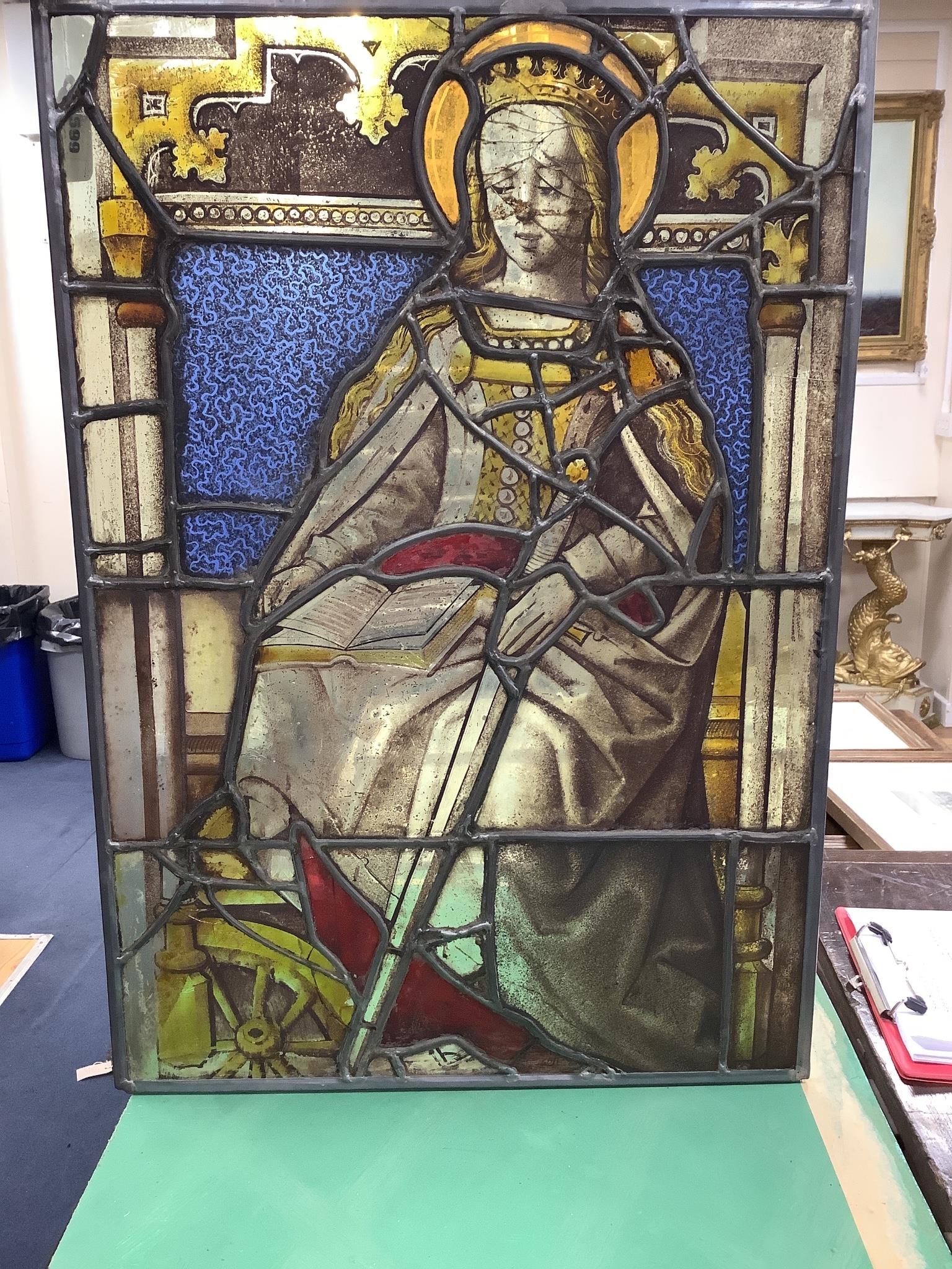 An early 16th century German stained leaded glass panel, depicting St. Catherine holding a sword and a book. 25 x 17.5ins. (later restorations and replacements)